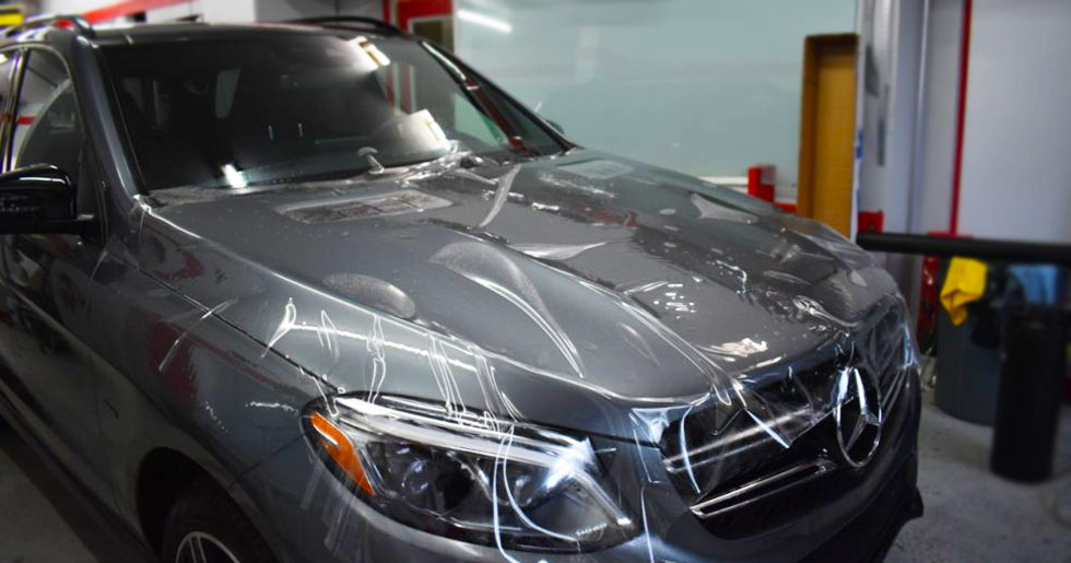 Protective film being applied to Mercedes SUV