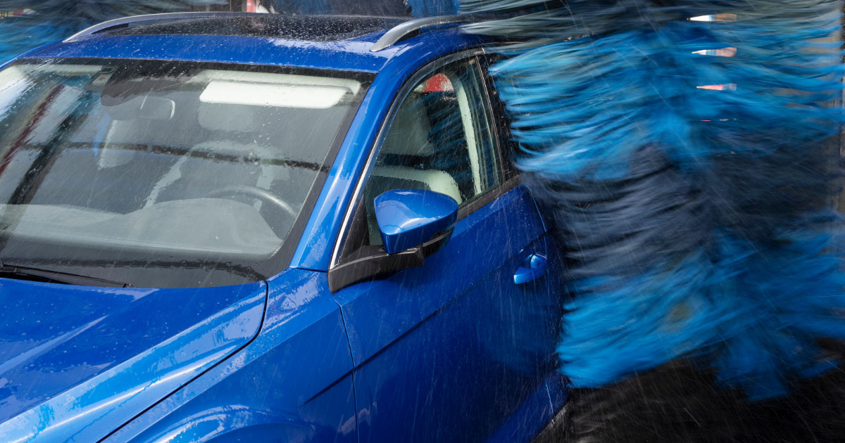 Blue car going through car wash