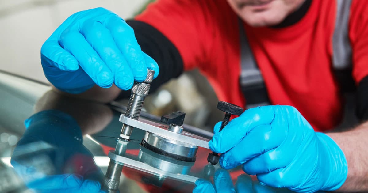 Man using glass repair kit to fix a chip
