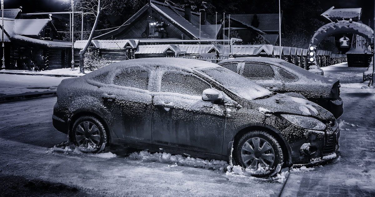 Dark colored car covered in ice and frost