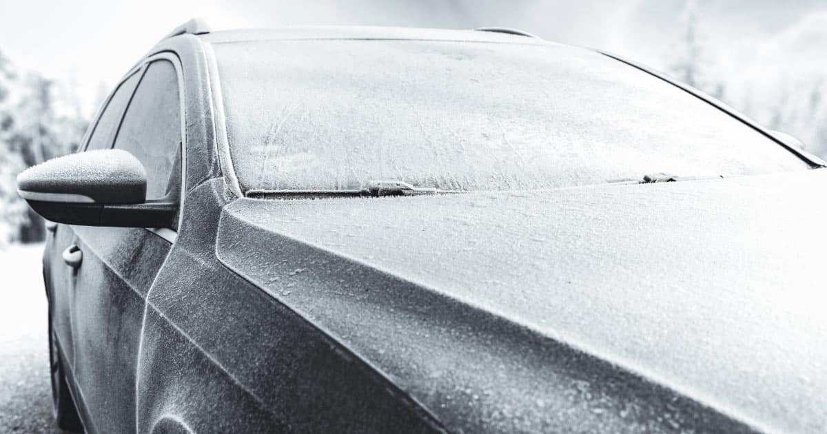 Black car with a layer of frost covering it