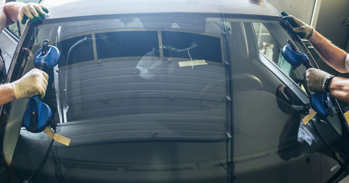 Pro glass installers putting in new windshield