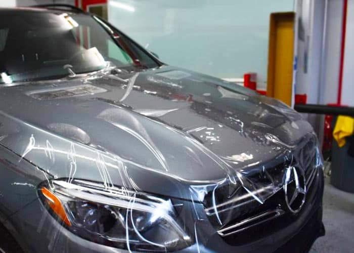 Paint protection film being applied to SUV